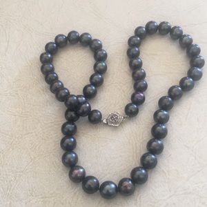 Black pearl strand with silver rose clasp